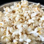 closeup of popped corn in stainless steel pan