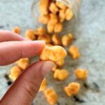 lady-holding-a-homemade-goldfish-cracker-close-up-